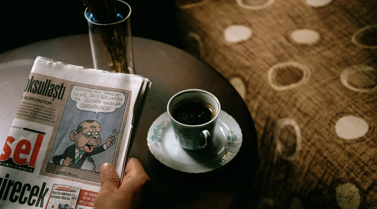 Coffee and newspaper on a café table